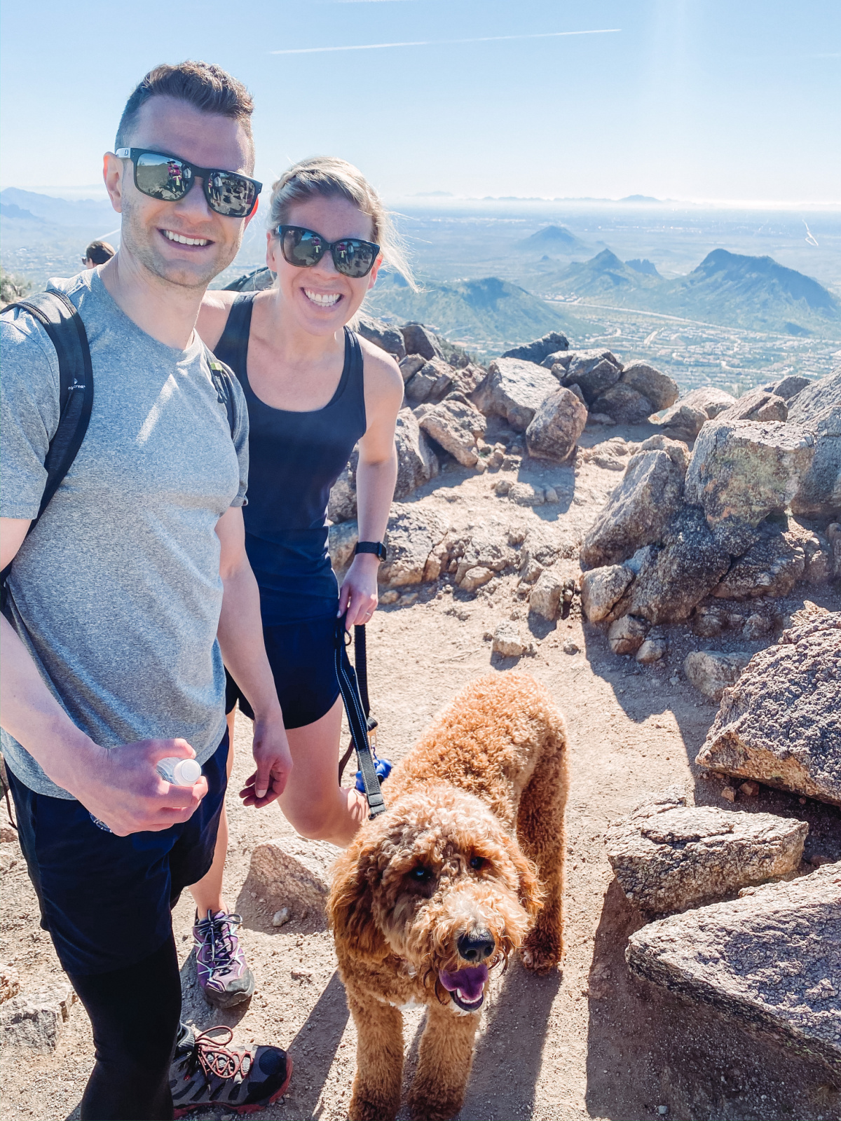 grant and hilari with a dog on a hike