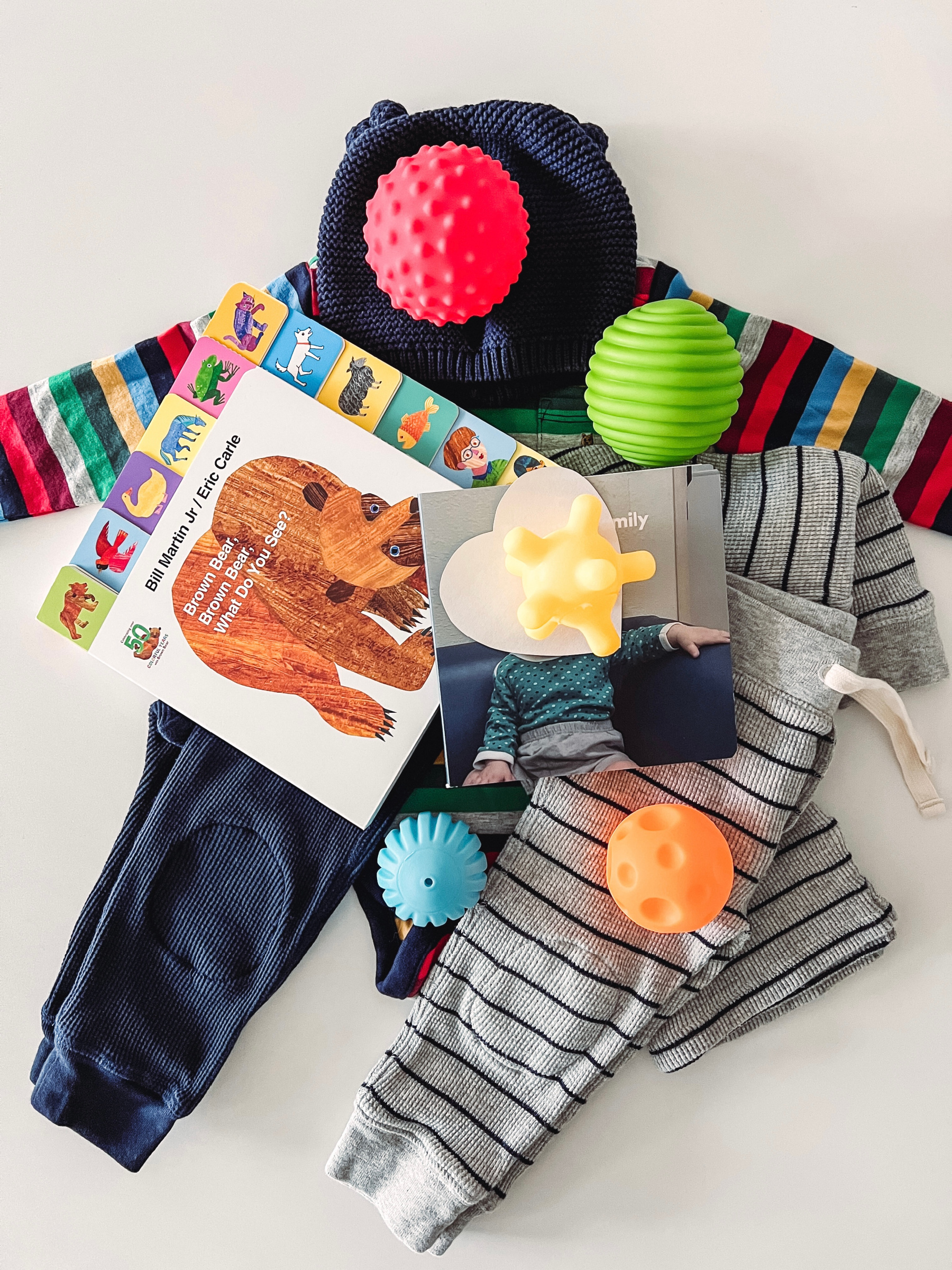 baby boy clothes and toys for a care package