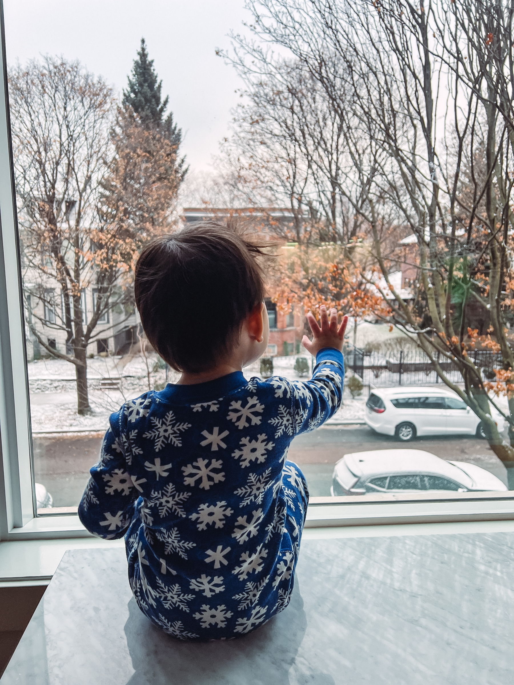 boy waving outside the window